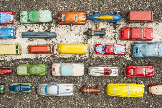Collection of antique toy cars on asphalt background