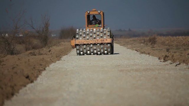 a road construction by a road roller