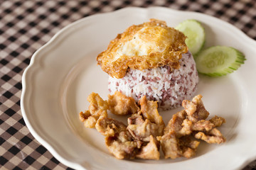 Rice topped with stir fried and fried pork