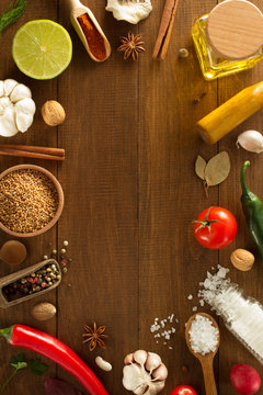 herbs and spices on wood background