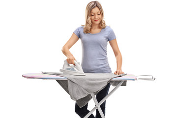 Woman ironing clothes and smiling