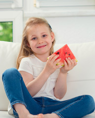 Cute little girl eating watermelon