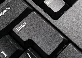 Part of modern black computer keyboard with enter button