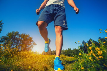 athlete running through the meadow.