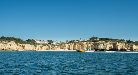 Fototapeta na wymiar ALGARVE COAST, PORTUGAL - MAY 19: A view of the city and the outlook boat near the coast Algarve in Portugal, 2016