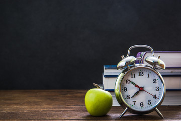 retro alarm clock and classroom chalkboard