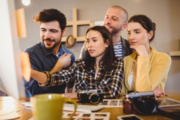 Team of graphic designers working on a computer
