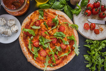 Italian pizza with tomatoes and rucola