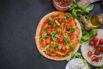Italian pizza with tomatoes and rucola