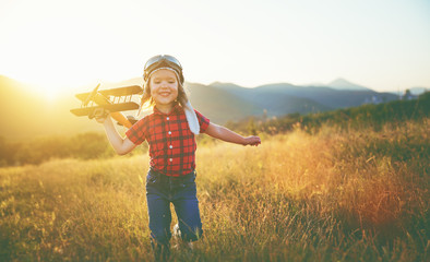 happy child dreams of traveling and playing with an airplane pil