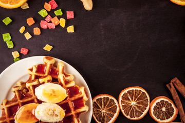Homemade waffles with orange jam and milk.