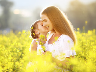 Happy family on summer. little girl child daughter hugging and k