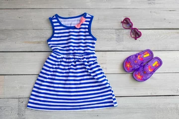 Deurstickers Beautiful children's blue dress for the girl, in sea style on a © smile35