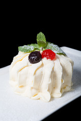 Pavlova dessert on a white plate