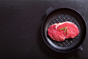 fresh meat with rosemary in a pan