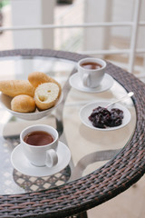 Obraz premium Beautiful breakfast on a cozy terrace. Wicker furniture