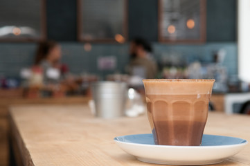 Cafe interior background with fresh coffee on the table in the c