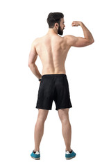 Rear view of young fit athlete flexing arm muscles. Full body length portrait isolated over white studio background.