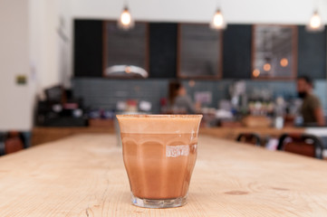Cafe interior background with fresh coffee on the table in the c