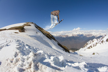 Naklejka na ściany i meble Ski rider jumping on mountains. Extreme ski freeride sport.