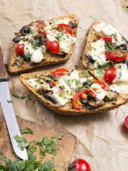 delicious bruschetta with tomatoes, cheese and mushrooms