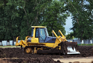Obraz na płótnie Canvas Bulldozer working at construction site