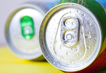Top part of beer cans with water drops.Close up view