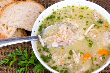 traditional barley soup with meat in a white bowl