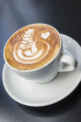 Swan cappuccino art coffee on black table
