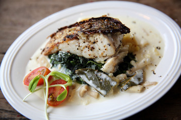 Grill sea bass fillets with crushed potatoes