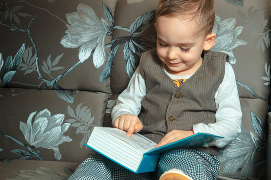 little boy read a book