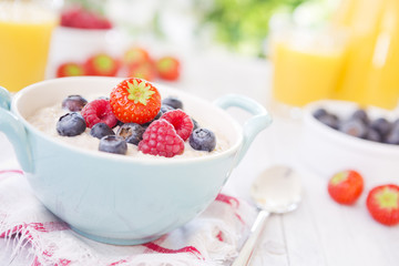 Oatmeal porridge with fruit on a rustic table