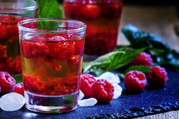 Alcoholic cocktail with whiskey, sugar and raspberries, selectiv