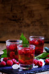 Alcoholic cocktail with whiskey, sugar and raspberries, selectiv