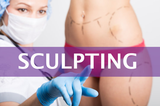sculpting written on a virtual screen. Internet technologies in medicine concept. medical doctor presses a finger on a virtual screen. cosmetic surgery, lifting and breast augmentation