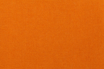 Bright orange background from textile material. Fabric with natural texture.