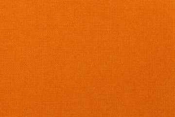 Bright orange background from textile material. Fabric with natural texture.