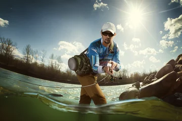 Raamstickers Fishing in a spring fed creek  © vitaliy_melnik