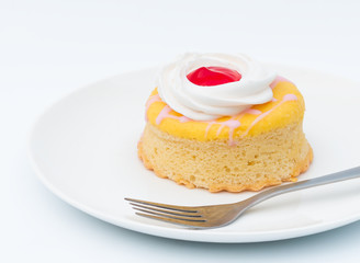 Butter cake with strawberry jam and whipped cream on a white background.