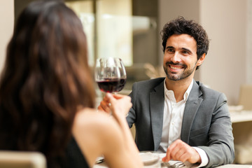 Couple toasting wineglasses in a luxury restaurant