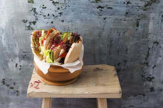 Pita bread filled with salad, cucumber, tomato, mozzarella and cress, vegetarian