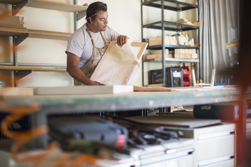 Man preparing canvas in workshop