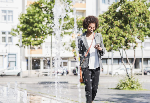 Smiling woman looking at her smartphone
