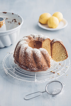 Sliced homemade lemon vanilla Gugelhupf on baking grid