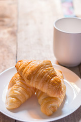 Danish pastry with coffee on the wooden table