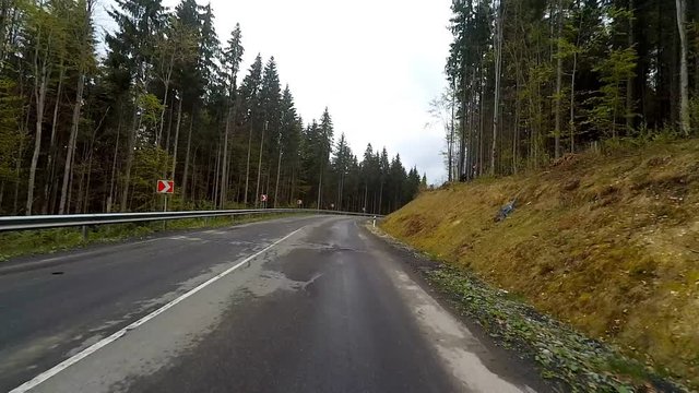 Driving on a mountain rural road. Point of view camera filming.