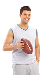 Confident young man holding a football