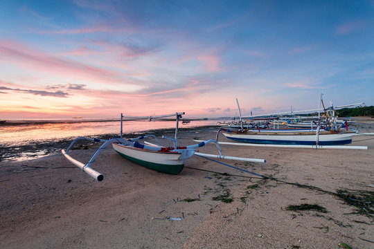 Holiday in Bali, Indonesia - Reflection Sunrise in Tanjong Benoa with boat