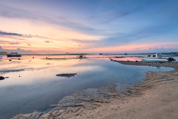 Holiday in Bali, Indonesia - Reflection Sunrise in Tanjong Benoa with boat