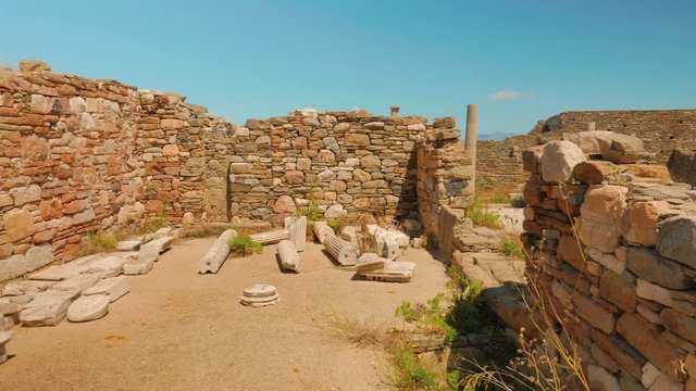 A pan shot featuring ancient house ruins in the Greek island of Delos
